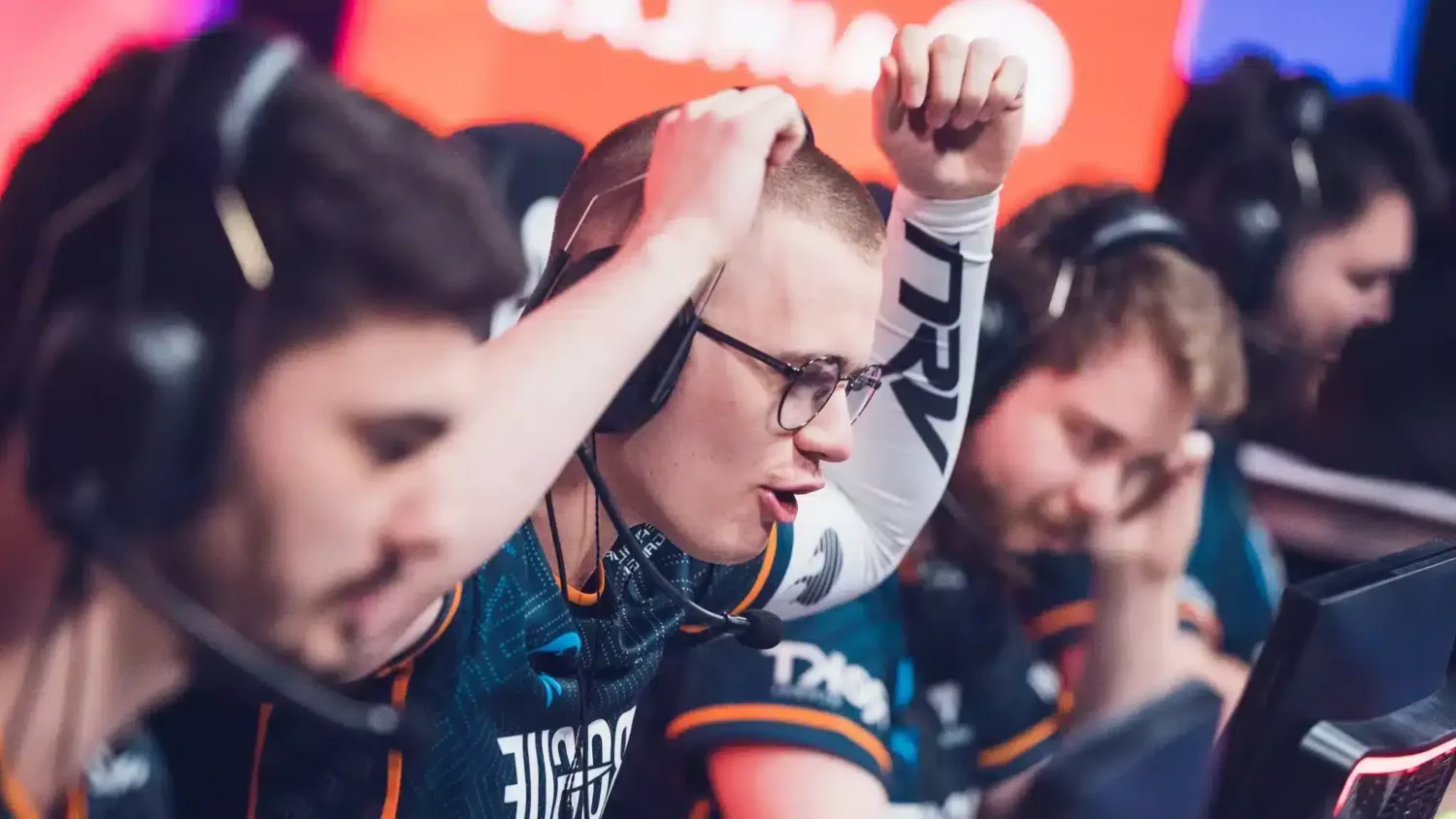 Focused professional gamer at a tournament wearing the NRV gaming sleeve